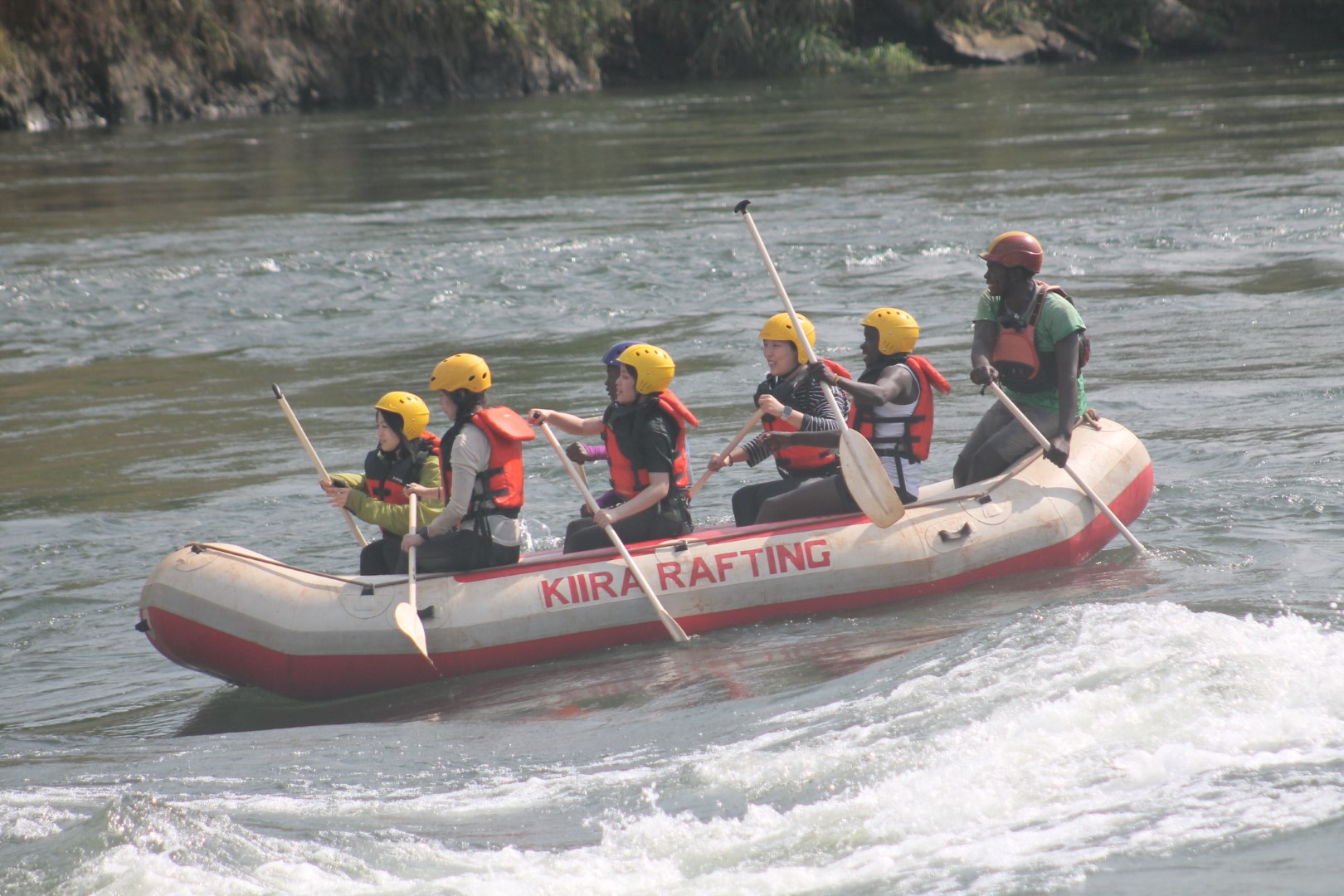 Paddlers in helmets and life jackets on the White Nile