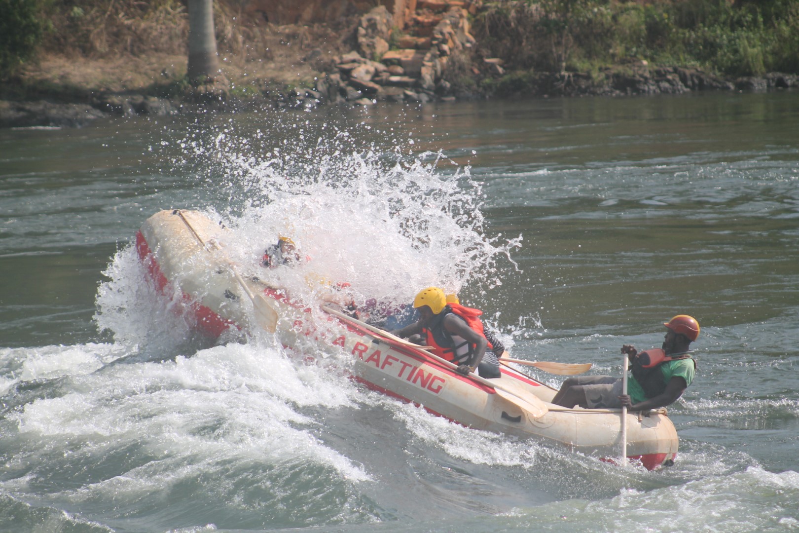 Guide steering a raft between rapids near Bujagali, Jinja