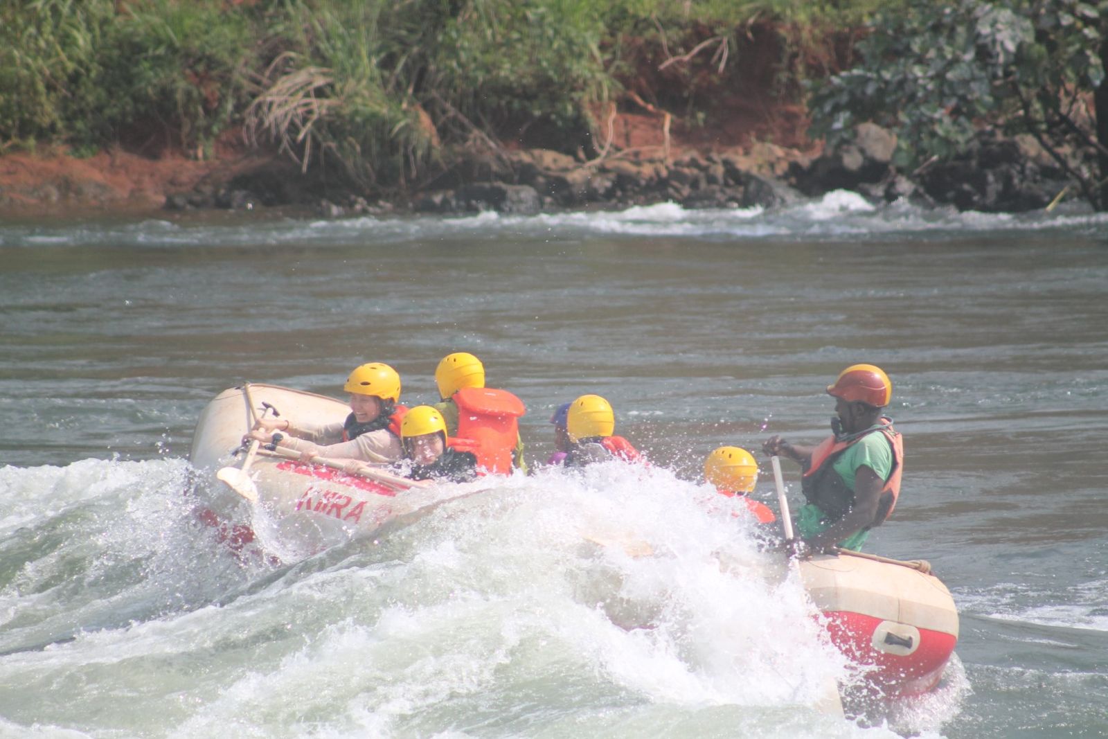 Rafters bracing as the raft drops into whitewater on the Nile