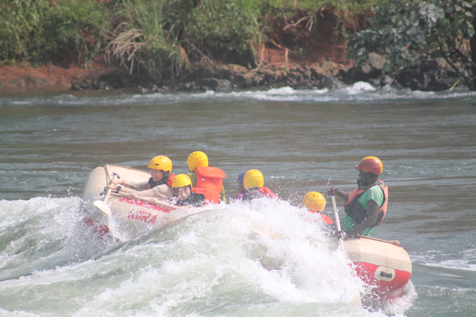 Rafters bracing as the raft drops into whitewater on the Nile