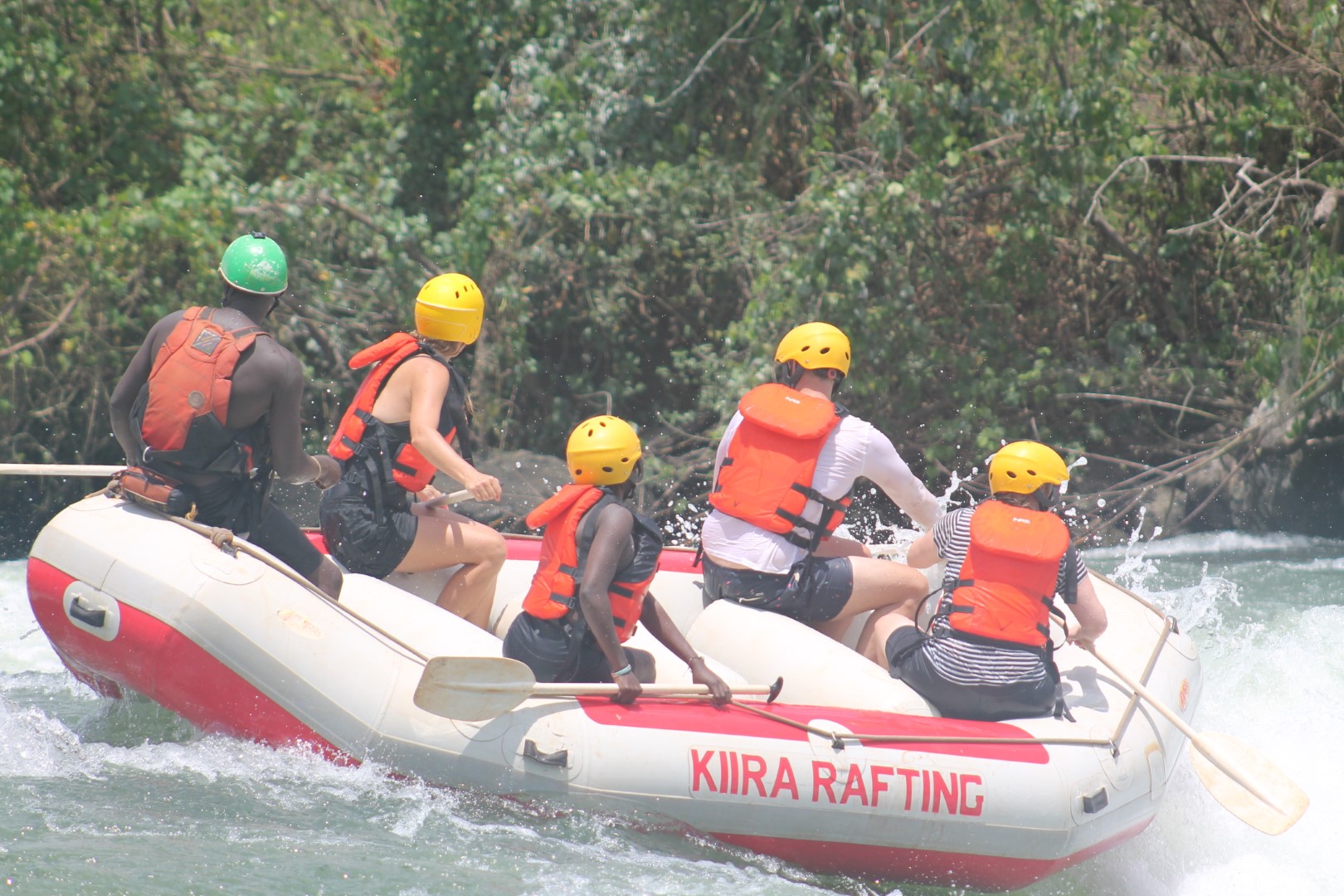 Raft team celebrating after running a Nile rapid